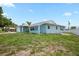 Charming single-story home with an attached garage is situated on a nicely sized lot with green lawn at 7322 Ellis Ln, Port Charlotte, FL 33981