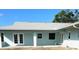 Back exterior elevation showing covered patio, french doors, and windows at 7322 Ellis Ln, Port Charlotte, FL 33981