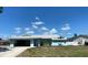 This well-maintained single-story home with attached two-car garage and a front lawn exudes classic curb appeal at 7322 Ellis Ln, Port Charlotte, FL 33981
