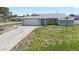 Charming single-story home with a well-maintained lawn and attached two-car garage at 7322 Ellis Ln, Port Charlotte, FL 33981