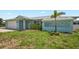 Inviting single-story home featuring a tidy lawn and an attached two-car garage at 7322 Ellis Ln, Port Charlotte, FL 33981