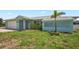 Charming single-story home with a two-car garage and a tropical palm tree at 7322 Ellis Ln, Port Charlotte, FL 33981