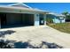 This single-Gathering home includes an attached garage with a concrete driveway and landscaping for a welcoming exterior at 7322 Ellis Ln, Port Charlotte, FL 33981