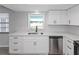 Bright kitchen with stainless steel appliances, white cabinets, and modern countertops at 7322 Ellis Ln, Port Charlotte, FL 33981