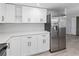 Bright kitchen with stainless steel appliances, white cabinets, and modern countertops at 7322 Ellis Ln, Port Charlotte, FL 33981