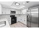 Modern kitchen with stainless steel appliances, white cabinets, and stylish countertops at 7322 Ellis Ln, Port Charlotte, FL 33981