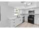 Well-lit kitchen with stainless steel appliances, white cabinets, and modern countertops at 7322 Ellis Ln, Port Charlotte, FL 33981