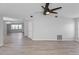 Spacious open-concept living area featuring a modern fan and new flooring at 7322 Ellis Ln, Port Charlotte, FL 33981