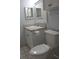 Cozy bathroom featuring a classic white vanity, toilet, and a minimalist mirror at 8220 12Th N Way # H, St Petersburg, FL 33702