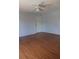 Empty bedroom with laminate floors and a white door and ceiling fan at 8220 12Th N Way # H, St Petersburg, FL 33702
