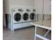 Functional laundry room with multiple commercial washing machines for convenience at 8220 12Th N Way # H, St Petersburg, FL 33702