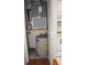 Compact utility closet with water heater and HVAC unit for efficient home maintenance at 8220 12Th N Way # H, St Petersburg, FL 33702