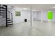 Spacious basement featuring tiled floors, a spiral staircase, and well-lit areas at 859 Harbor Hill Dr, Safety Harbor, FL 34695