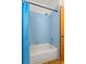 Bathroom featuring blue tiles in the shower and a white tub at 859 Harbor Hill Dr, Safety Harbor, FL 34695