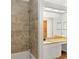 Bathroom with beige tile wall, white cabinets and a granite countertop at 859 Harbor Hill Dr, Safety Harbor, FL 34695