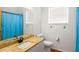 Bathroom featuring a granite countertop, white cabinets, tile flooring, and a window for natural light at 859 Harbor Hill Dr, Safety Harbor, FL 34695