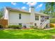 Back of the house featuring white siding, a screened porch, and a well-maintained lawn at 859 Harbor Hill Dr, Safety Harbor, FL 34695