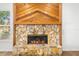Stone fireplace with wooden mantle and chevron design at 859 Harbor Hill Dr, Safety Harbor, FL 34695