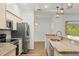 Kitchen featuring granite countertops and stainless appliances with open floor plan at 859 Harbor Hill Dr, Safety Harbor, FL 34695