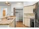 Modern kitchen featuring granite countertops, stainless steel appliances, and a walk-in pantry at 859 Harbor Hill Dr, Safety Harbor, FL 34695