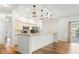 Bright open kitchen with stainless steel appliances, granite countertops and white cabinetry at 859 Harbor Hill Dr, Safety Harbor, FL 34695