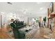 Open concept living room featuring wood floors, fireplace, view to kitchen and sliding glass doors at 859 Harbor Hill Dr, Safety Harbor, FL 34695