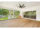 Large, screened porch with a wooden swing and ample space for relaxing and enjoying the outdoors at 859 Harbor Hill Dr, Safety Harbor, FL 34695