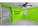 A spacious room with vibrant green walls, tiled flooring, and a ceiling fan for added comfort at 859 Harbor Hill Dr, Safety Harbor, FL 34695