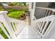 Exterior stairs leading to a backyard with grass, landscaping and a wooden fence at 859 Harbor Hill Dr, Safety Harbor, FL 34695