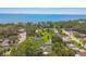 Scenic aerial view of a waterfront community with lush greenery, mature trees, and stunning ocean views at 859 Patterson Dr, Sarasota, FL 34234