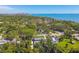Expansive aerial view of lush, tree-lined community with waterfront access and distant city skyline at 859 Patterson Dr, Sarasota, FL 34234