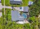 Aerial view of a home with a pool, patio, and well-maintained landscaping surrounded by lush greenery at 859 Patterson Dr, Sarasota, FL 34234