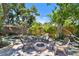 Backyard fire pit area with seating and lush landscaping for outdoor enjoyment and relaxation at 859 Patterson Dr, Sarasota, FL 34234