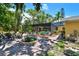 A beautiful backyard features a screened in pool, patio, and lush, mature landscaping at 859 Patterson Dr, Sarasota, FL 34234