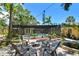 Relaxing backyard featuring a cozy fire pit area, sparkling pool, and lush greenery for a private outdoor retreat at 859 Patterson Dr, Sarasota, FL 34234