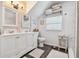 Bathroom featuring granite countertop, double sinks, large mirror, and modern fixtures at 859 Patterson Dr, Sarasota, FL 34234