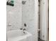 Cozy bathroom is tiled and features a standard tub and storage shelving at 859 Patterson Dr, Sarasota, FL 34234
