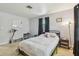 Neutral bedroom is naturally well-lit with tile flooring, neutral paint, and bed at 859 Patterson Dr, Sarasota, FL 34234