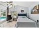 Bright bedroom with a desk overlooking the pool, vaulted ceiling, and tiled flooring at 859 Patterson Dr, Sarasota, FL 34234