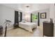Bright bedroom features tile flooring, neutral paint, and a comfortable bed at 859 Patterson Dr, Sarasota, FL 34234