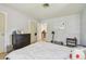 Comfortable and well-lit bedroom with white bedding and gray flooring and walls at 859 Patterson Dr, Sarasota, FL 34234