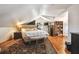 Cozy bedroom with neutral walls, wood floors, a tufted headboard, and a bookshelf, creating a comfortable retreat at 859 Patterson Dr, Sarasota, FL 34234