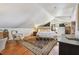 Bedroom featuring hardwood floors, large rug, accent chair, and sloped ceilings at 859 Patterson Dr, Sarasota, FL 34234