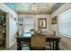 Beautiful dining room features a unique artistic ceiling, chandelier, wood table, and seating for six at 859 Patterson Dr, Sarasota, FL 34234