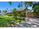 A view of the side and rear of the home showing the backyard entrance at 859 Patterson Dr, Sarasota, FL 34234