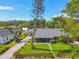 Charming home featuring a well-manicured lawn, a quaint fence, and mature trees at 859 Patterson Dr, Sarasota, FL 34234