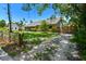 Well maintained home with mature trees and a gravel drive leading to the backyard at 859 Patterson Dr, Sarasota, FL 34234