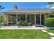 A spacious screened in front porch provides ample space for outdoor seating at 859 Patterson Dr, Sarasota, FL 34234