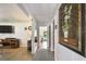 Bright hallway with wood floors and view through to the pool in backyard at 859 Patterson Dr, Sarasota, FL 34234
