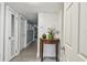 Welcoming hallway with wood-look flooring, classic table and lighting throughout at 859 Patterson Dr, Sarasota, FL 34234